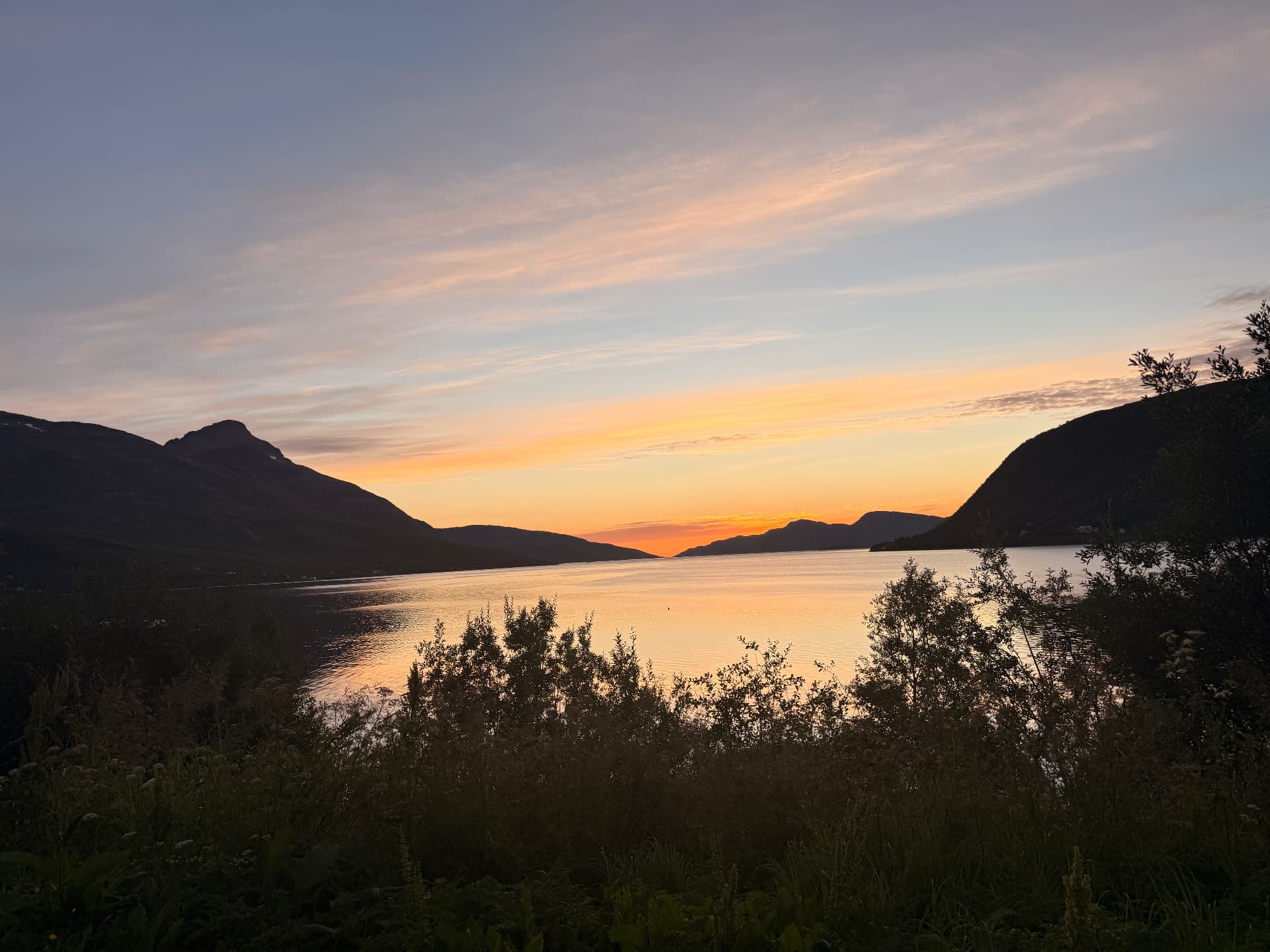 Sunset over a fjord near Tromsø, with mountains on both sides